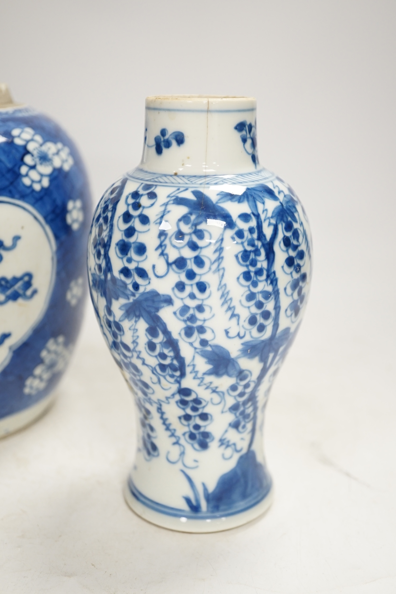 A Chinese Kangxi blue and white jar and a similar vase, jar 19.5cm high. Condition - both cracked and chipped, poor